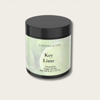 Jar of Key Lime Cleansing Sugar Scrub by Lantern & Veil on a light gray background