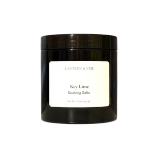 Black container of 'Key Lime' soaking salts by Lantern & Veil on a white background