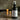 Lantern & Veil Pirate's Cavern room spray in a 4 oz matte black bottle on a wooden table with glowing candles.