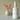 White bottle of Mango Dragonfruit fragrance mist next to a white vase with red branches on a beige background
