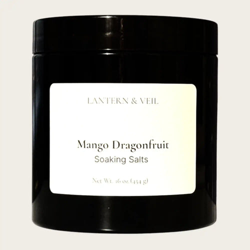 Black container of Mango Dragonfruit soaking salts by Lantern & Veil on a light gray background