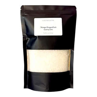 Black packaging of Mango Dragonfruit Soaking Salts with a visible label on a white background
