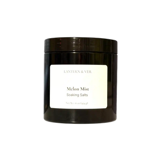 Black container of 'Melon Mist' soaking salts by Lantern & Veil on a white background