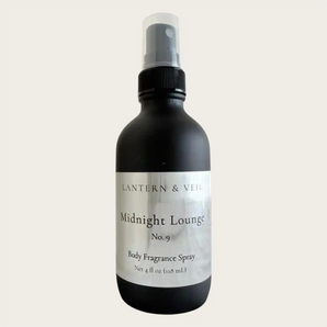 Black body fragrance spray bottle labeled 'Midnight Lounge' by Lantern & Veil on a light gray background