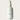 White bottle of 'Midnight Vanilla' fragrance mist with a label on a light gray background