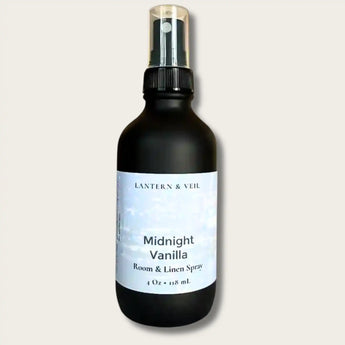 Black room spray bottle labeled 'Midnight Vanilla' by Lantern & Veil on a light gray background