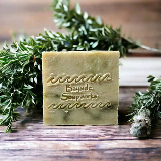 Renewal Zen Soap & Shampoo Bar on a wood surface with rosemary in background