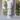 Body powder canister labeled 'Sandalwood Vanilla' on a surface with a blurred window background