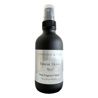Black body fragrance spray bottle labeled 'Storm Skies' by Lantern & Veil on a white background