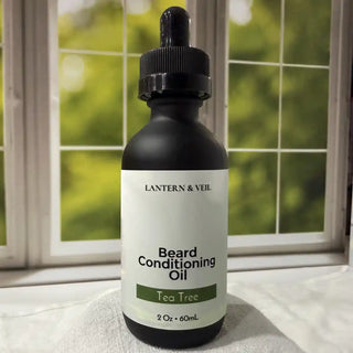 Bottle of Lantern & Veil Beard Conditioning Oil with Tea Tree scent on a windowsill.