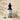 Bottle of Lantern & Veil Beard Conditioning Oil with tea tree leaves on a beige background