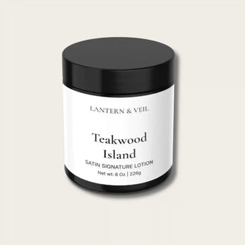 Lantern & Veil Teakwood Island satin signature lotion jar on a light beige background