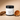Lotion jar labeled 'Teakwood Island' by Lantern & Veil on a beige background with decorative elements.