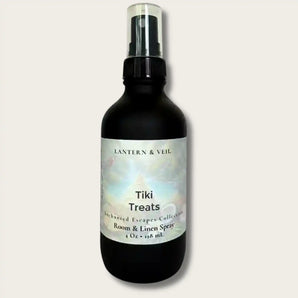 Black spray bottle labeled 'Tiki Treats' by Lantern & Veil on a light gray background