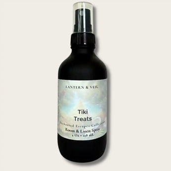 Black spray bottle labeled 'Tiki Treats' by Lantern & Veil on a light gray background