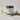 Handmade body scrub jar labeled 'Velvet Moonlight' with flowers and a vanilla bean on a light background